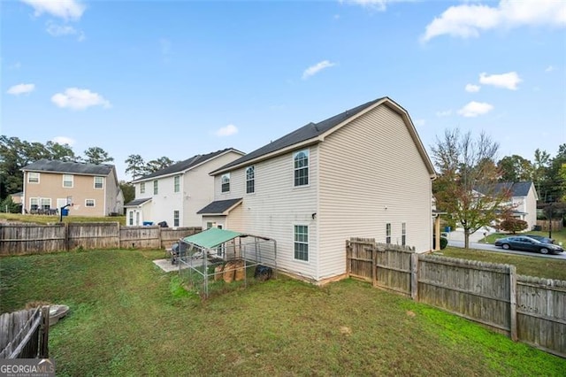 back of house with a lawn