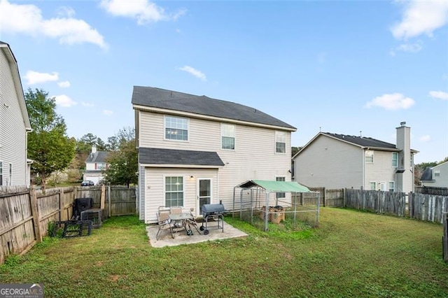 rear view of property with a yard and a patio