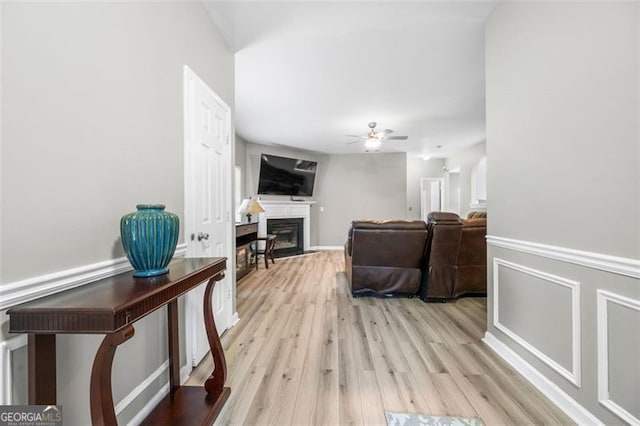 living room with ceiling fan and light hardwood / wood-style floors