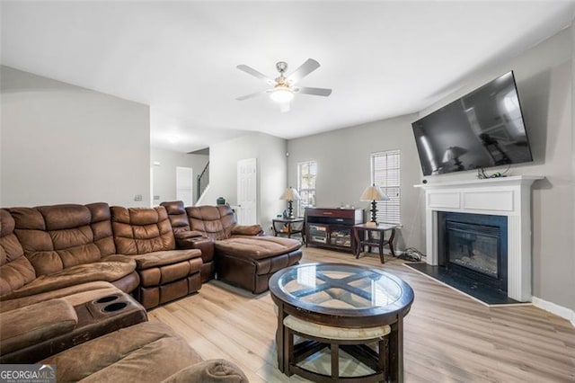 living room featuring ceiling fan and light wood-type flooring