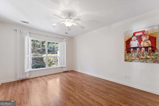 empty room featuring hardwood / wood-style flooring and ceiling fan