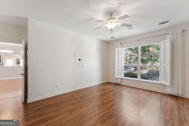 empty room with ceiling fan and dark hardwood / wood-style flooring