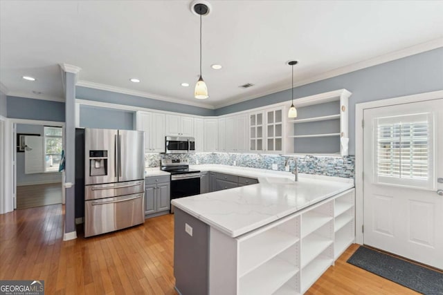 kitchen with decorative light fixtures, white cabinetry, gray cabinetry, kitchen peninsula, and stainless steel appliances