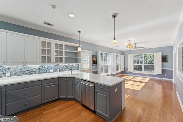 kitchen featuring ornamental molding, decorative light fixtures, gray cabinets, and stainless steel dishwasher