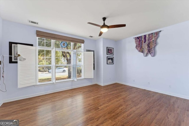 empty room with wood-type flooring and ceiling fan