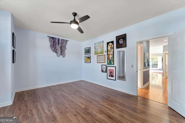 unfurnished room with dark hardwood / wood-style floors and ceiling fan