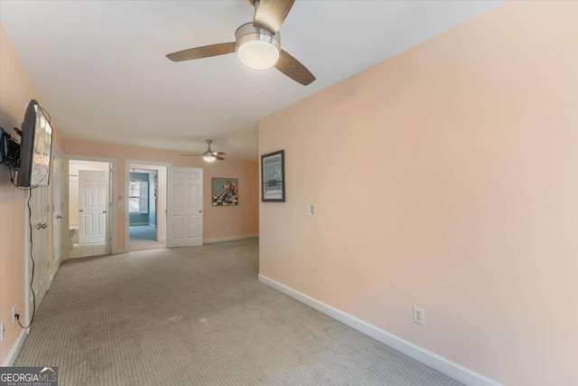 empty room with ceiling fan and light colored carpet