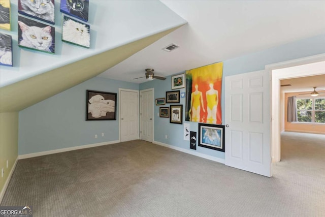 unfurnished living room featuring carpet and ceiling fan