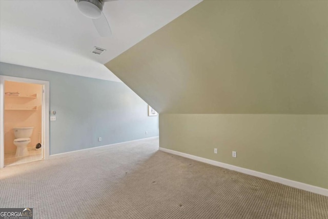 additional living space featuring ceiling fan, light colored carpet, and lofted ceiling