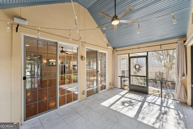 unfurnished sunroom featuring vaulted ceiling and ceiling fan