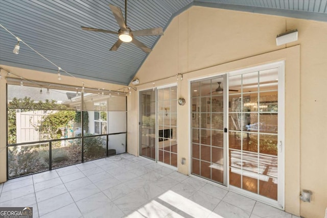 unfurnished sunroom featuring ceiling fan and lofted ceiling