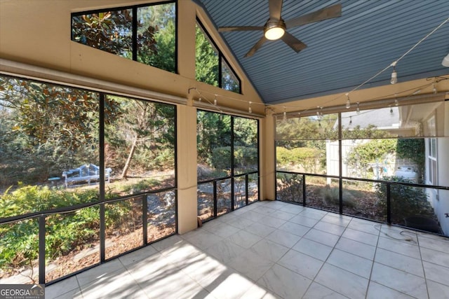 unfurnished sunroom featuring lofted ceiling and ceiling fan