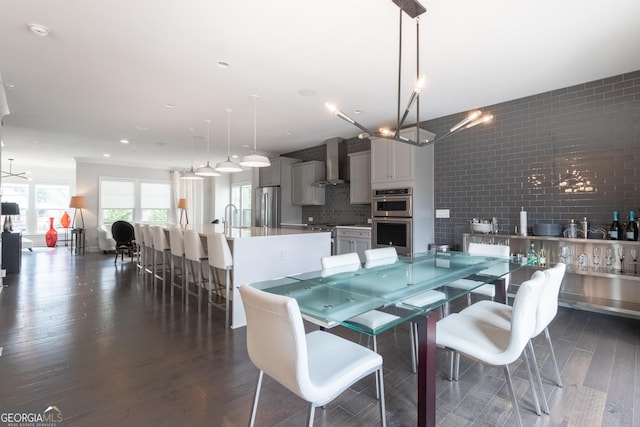 dining space featuring sink and dark hardwood / wood-style flooring