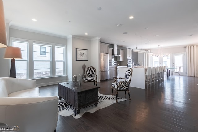 living room with crown molding and dark hardwood / wood-style floors