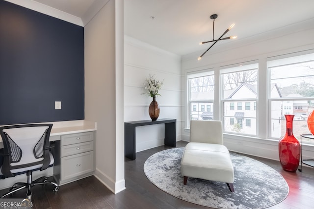 office space with ornamental molding, dark hardwood / wood-style flooring, built in desk, and a notable chandelier