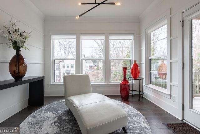 living area featuring crown molding and dark hardwood / wood-style floors