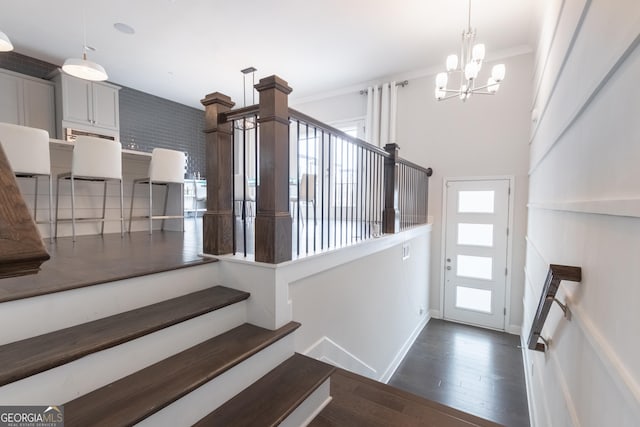 interior space with crown molding, dark wood-type flooring, and a chandelier