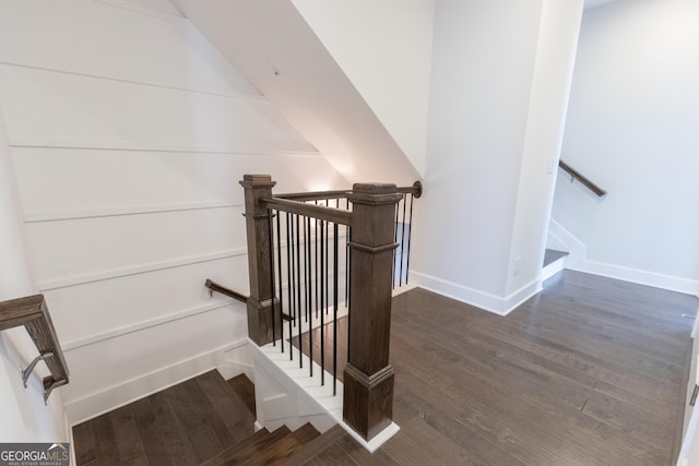 stairs featuring hardwood / wood-style floors