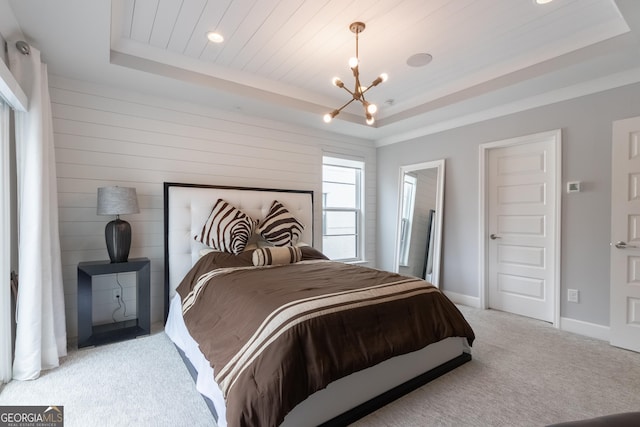 carpeted bedroom featuring an inviting chandelier, wood ceiling, and a tray ceiling