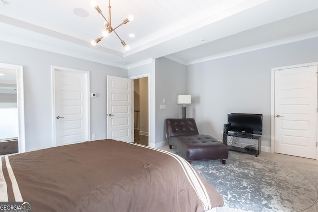 carpeted bedroom with an inviting chandelier, a tray ceiling, and crown molding