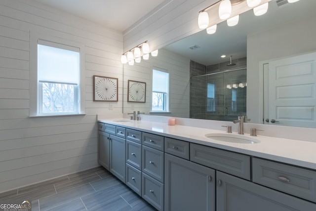 bathroom featuring vanity, an enclosed shower, and a wealth of natural light