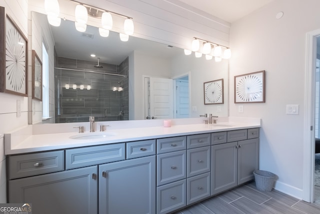 bathroom featuring vanity and an enclosed shower