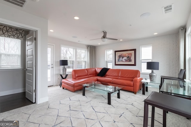 living room with ceiling fan and plenty of natural light