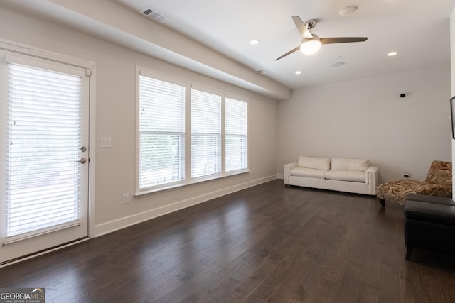 unfurnished living room with dark hardwood / wood-style floors and ceiling fan