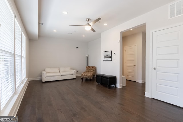 living area with dark hardwood / wood-style floors and ceiling fan