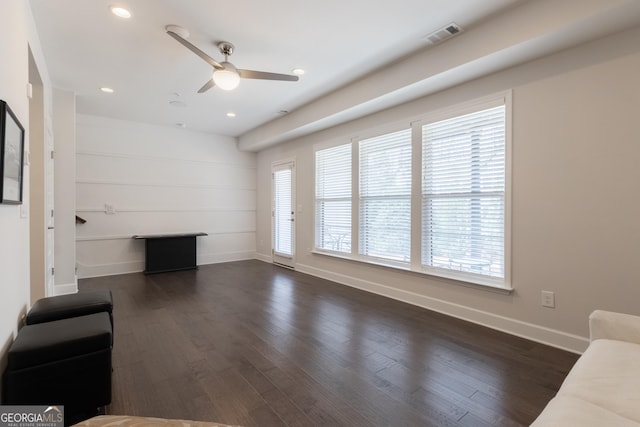 unfurnished living room with dark wood-type flooring and ceiling fan