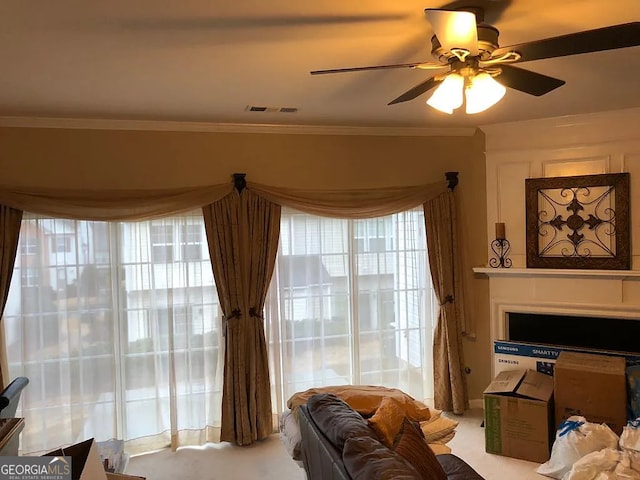 living room featuring crown molding and ceiling fan