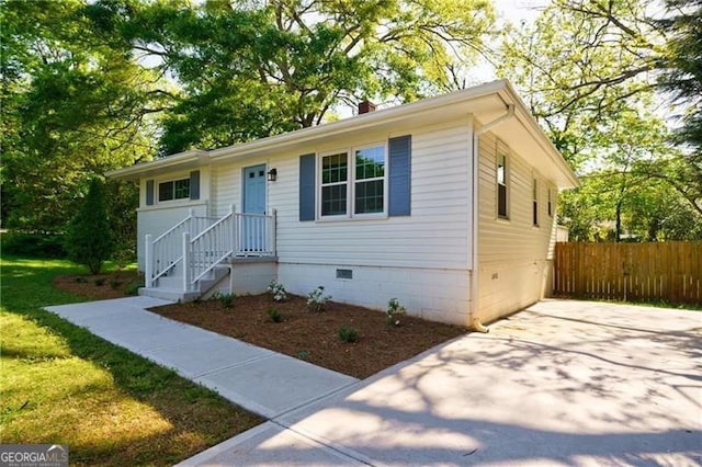 ranch-style home with crawl space, fence, and a chimney