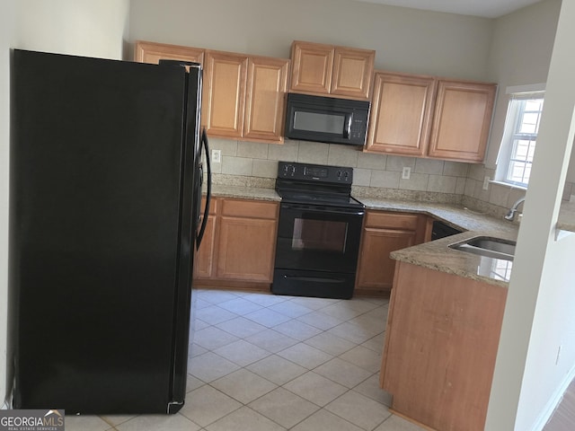 kitchen with tasteful backsplash, sink, light tile patterned floors, and black appliances