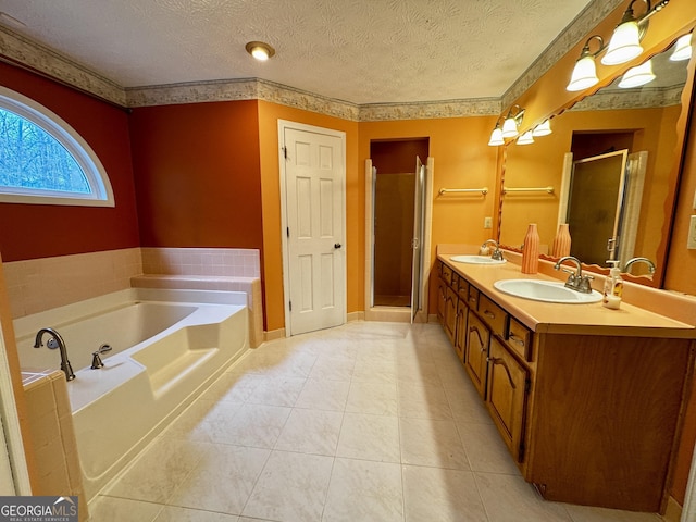 bathroom with vanity, tile patterned flooring, a textured ceiling, and separate shower and tub