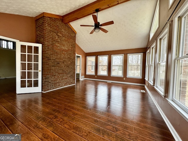 interior space with french doors, ceiling fan, and vaulted ceiling with beams