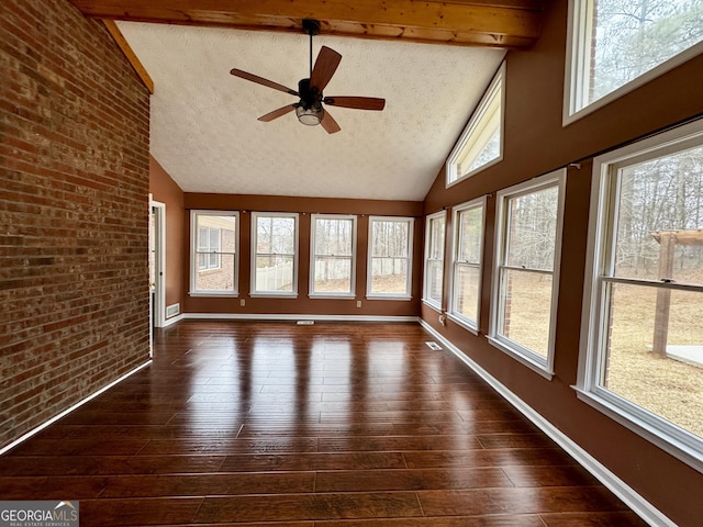 unfurnished sunroom with ceiling fan and lofted ceiling with beams