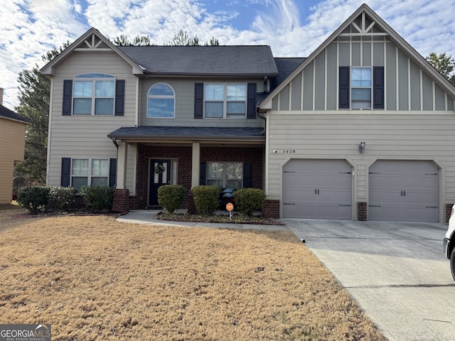 view of front of property with a garage and a front lawn