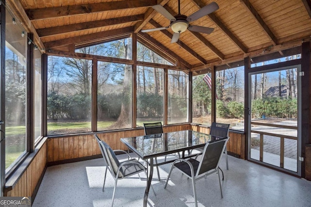 unfurnished sunroom with plenty of natural light, ceiling fan, and lofted ceiling with beams