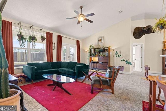 living room with vaulted ceiling, ceiling fan, carpet floors, and french doors