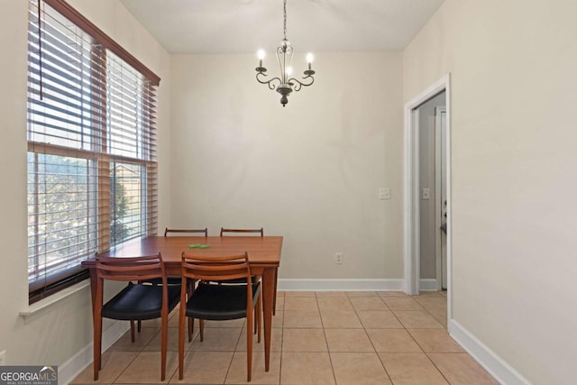 dining space featuring a notable chandelier and light tile patterned floors