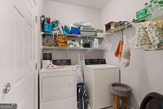 clothes washing area with separate washer and dryer