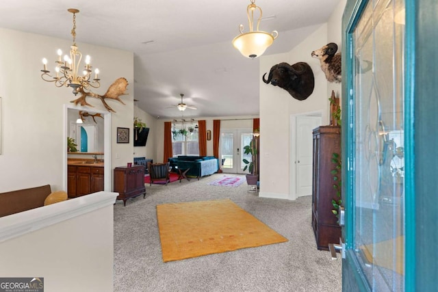 carpeted living room with vaulted ceiling, ceiling fan, sink, and french doors