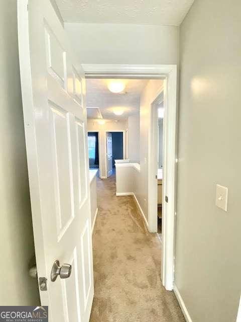 corridor with light colored carpet