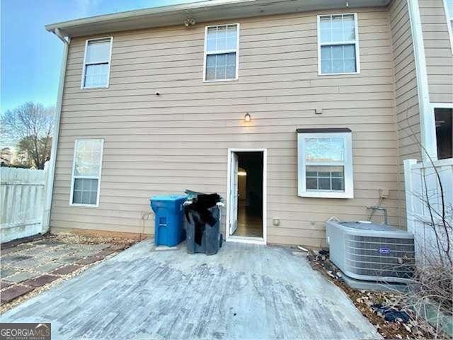 back of property featuring central AC