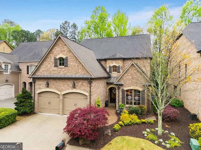 french country style house with a garage