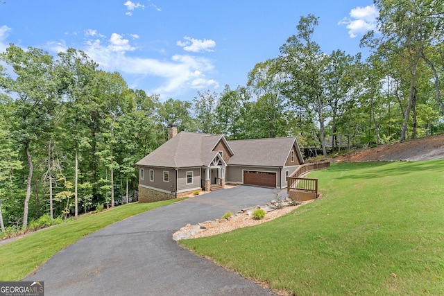 view of front of property featuring a garage and a front lawn