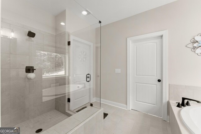 bathroom with tile patterned flooring and separate shower and tub