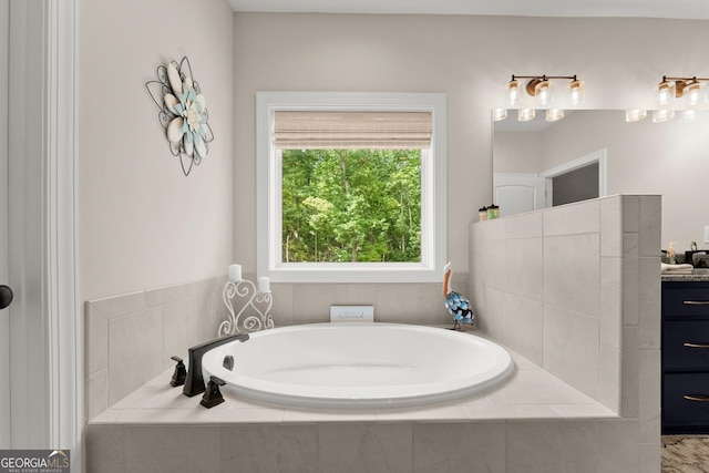 bathroom with a relaxing tiled tub and vanity