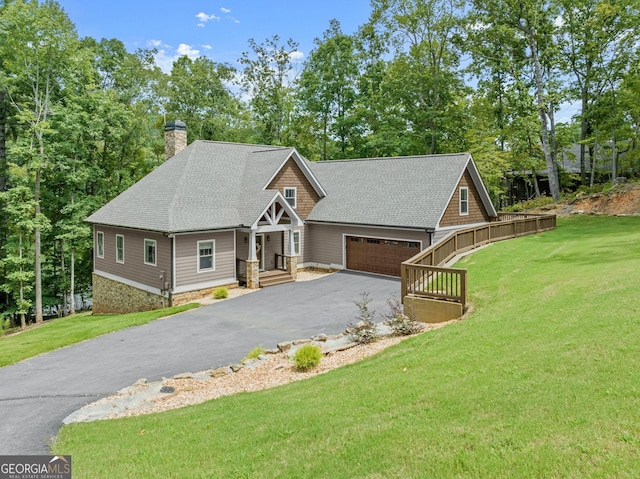 craftsman-style house featuring a garage and a front lawn