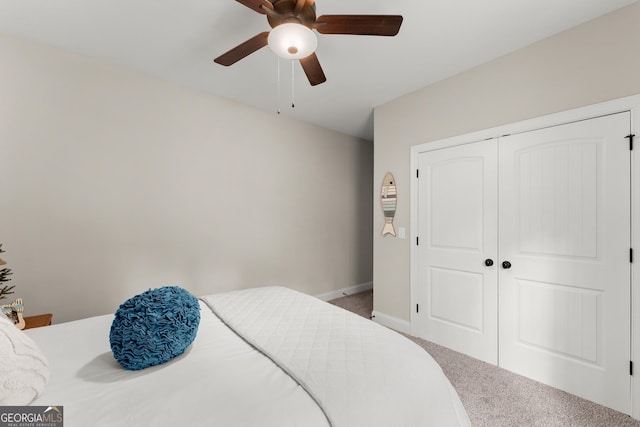 carpeted bedroom with ceiling fan and a closet